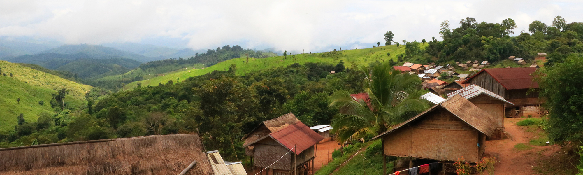 Landsby med hus i frodig fjellområde i Laos