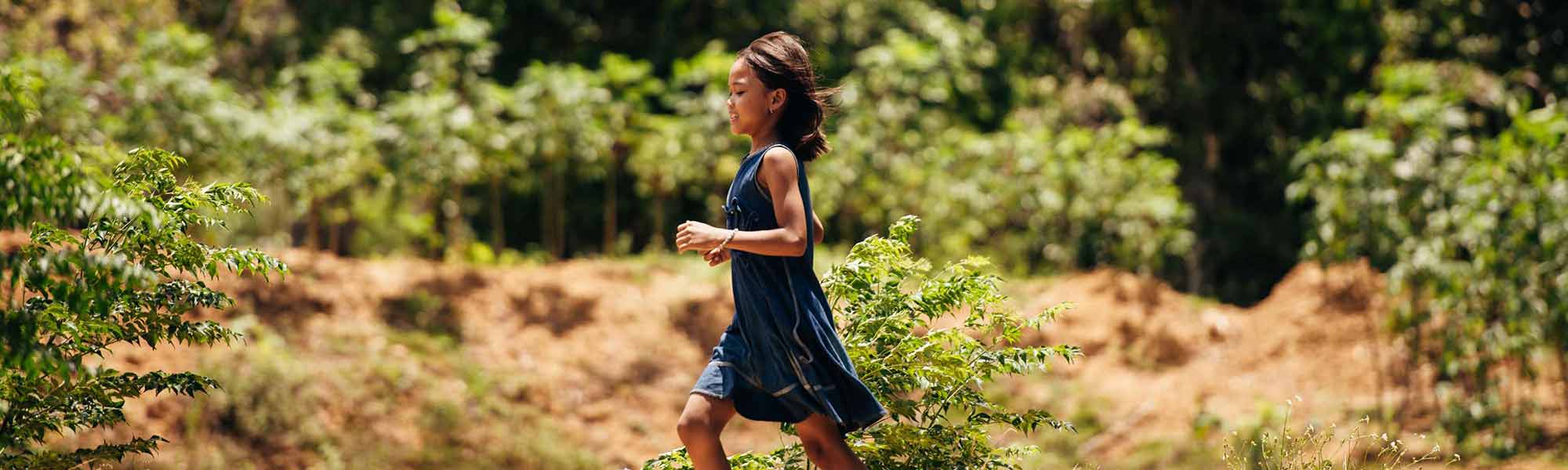 Jente fra Vietnam løper i fint naturlandskap.