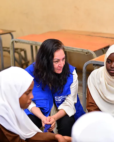 Reena prater med unge jenter.