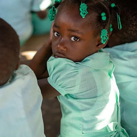 Jente fra Haiti er på skolen.